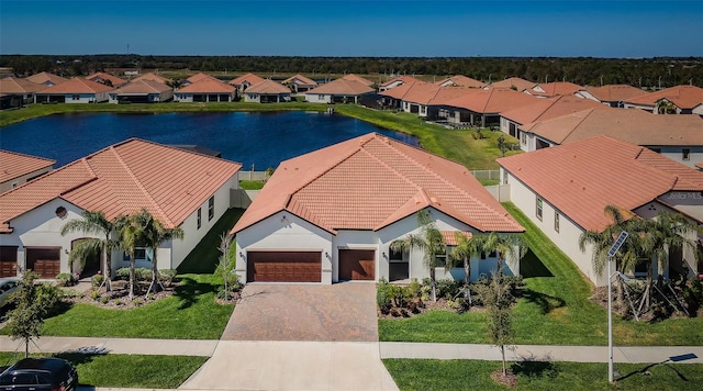 birds eye view of property with a water view and a residential view