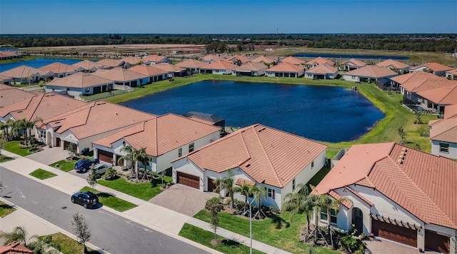 birds eye view of property featuring a water view and a residential view