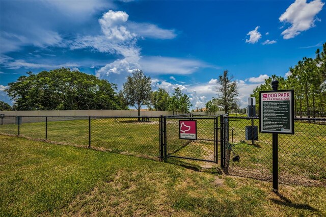 exterior space with fence and a lawn