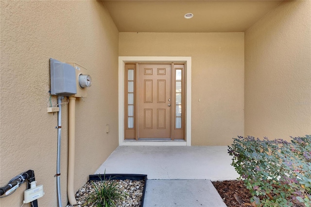 doorway to property with stucco siding