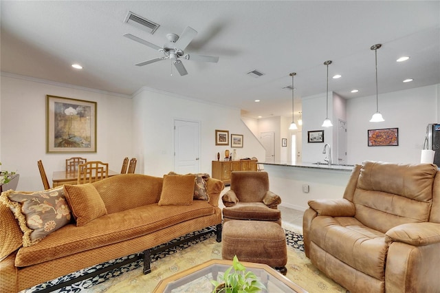 carpeted living room with recessed lighting, visible vents, and ornamental molding