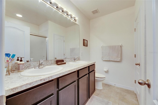 bathroom with a sink, visible vents, double vanity, and a shower stall