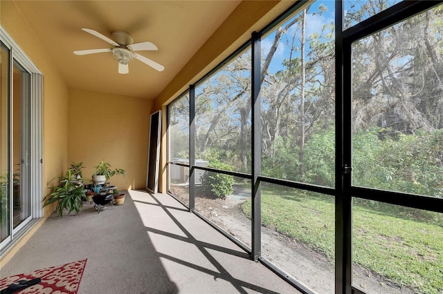 unfurnished sunroom with a ceiling fan