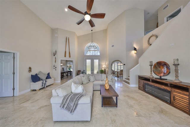 living area featuring ceiling fan, visible vents, baseboards, stairs, and french doors