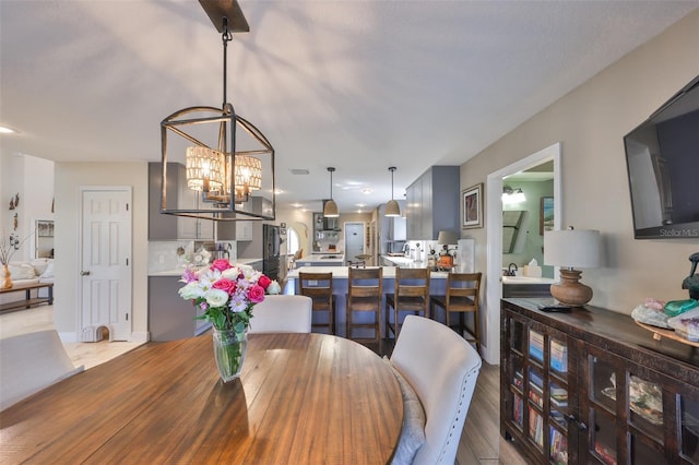 dining area featuring a notable chandelier and wood finished floors