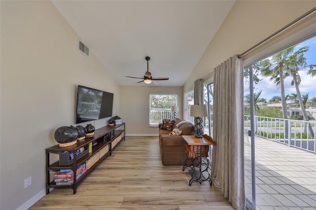 interior space with ceiling fan, visible vents, and vaulted ceiling