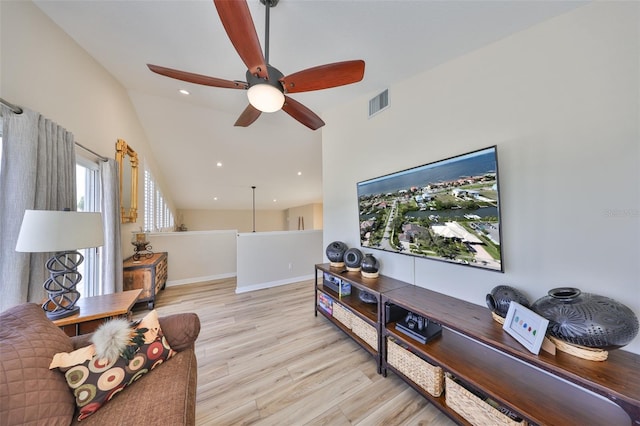 living room featuring baseboards, visible vents, lofted ceiling, wood finished floors, and recessed lighting