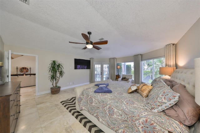 bedroom featuring ceiling fan, baseboards, a textured ceiling, and french doors