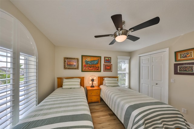 bedroom featuring ceiling fan, a closet, and wood finished floors