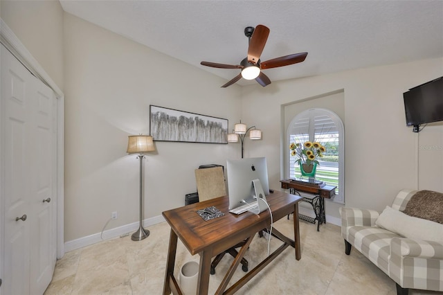 office featuring ceiling fan and baseboards