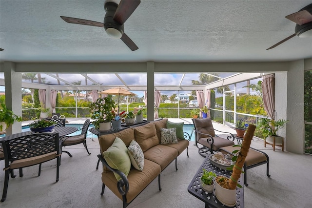 sunroom with a wealth of natural light and a ceiling fan