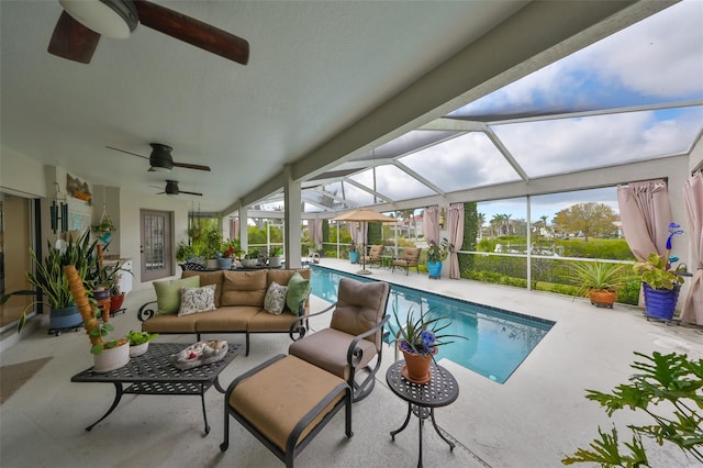 pool with glass enclosure, a patio, an outdoor living space, and ceiling fan