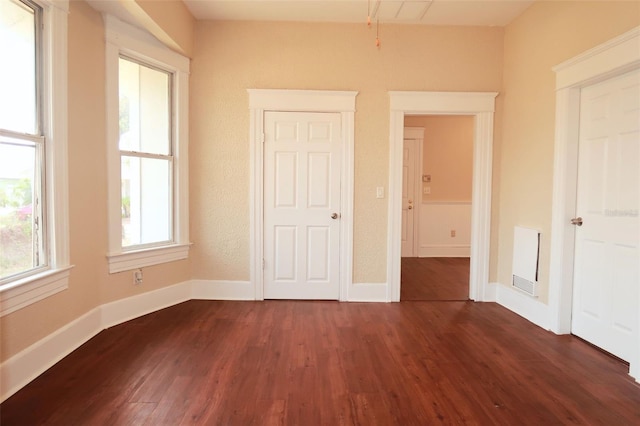 unfurnished bedroom featuring dark wood-style floors and baseboards