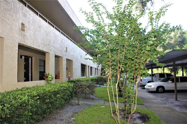 4983 Puritan Cir Unit 524, Tampa, FL 33617 - view of home's exterior featuring covered parking and stucco siding
