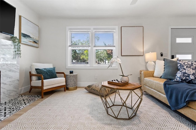 living area with wood finished floors and baseboards