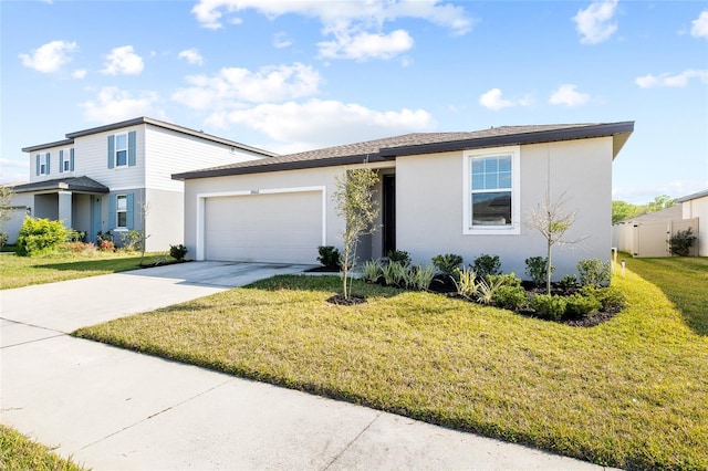 view of front of home featuring a garage, a front lawn, concrete driveway, and stucco siding