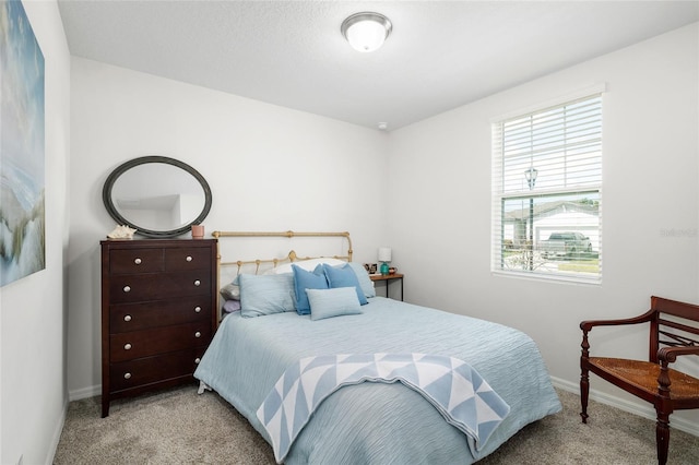 bedroom with carpet floors and baseboards