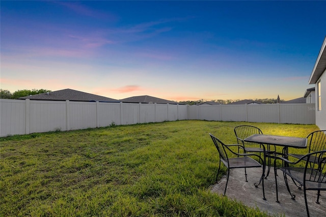 view of yard featuring outdoor dining space and a fenced backyard