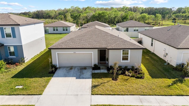 view of front facade featuring an attached garage, roof with shingles, concrete driveway, and a front yard