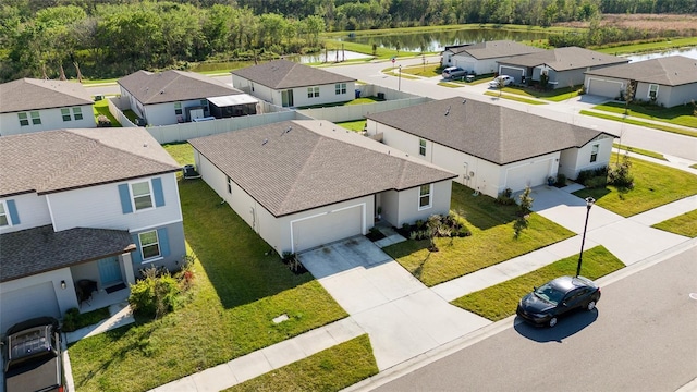 birds eye view of property with a water view and a residential view