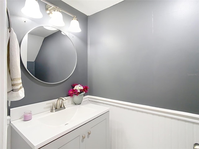 bathroom featuring a wainscoted wall and vanity