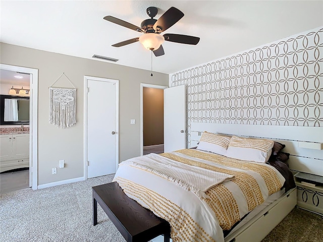 bedroom with carpet, visible vents, a ceiling fan, connected bathroom, and baseboards