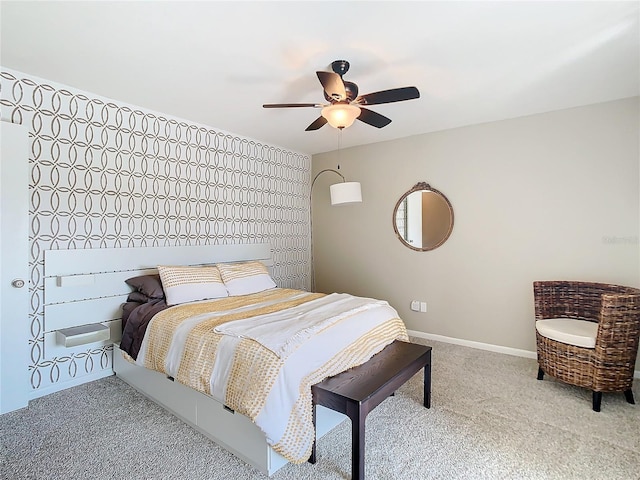 bedroom with a ceiling fan, carpet flooring, and baseboards