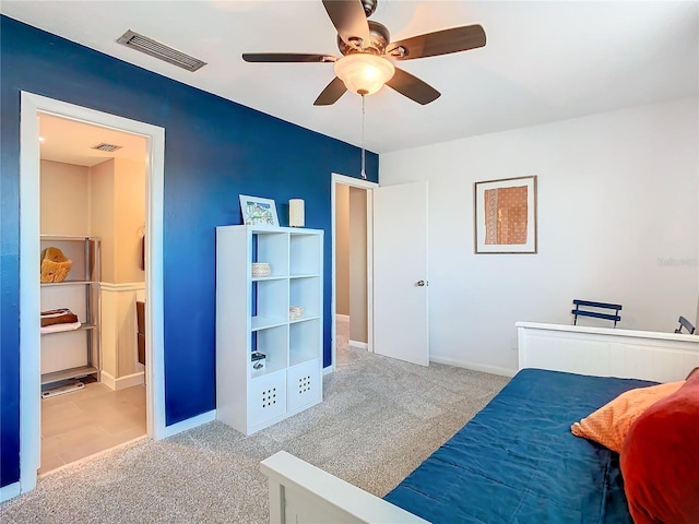 carpeted bedroom with visible vents, ceiling fan, and baseboards