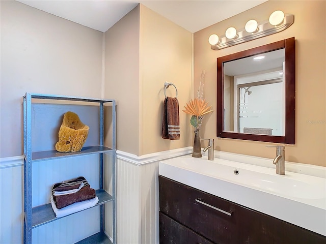 bathroom with a wainscoted wall and vanity