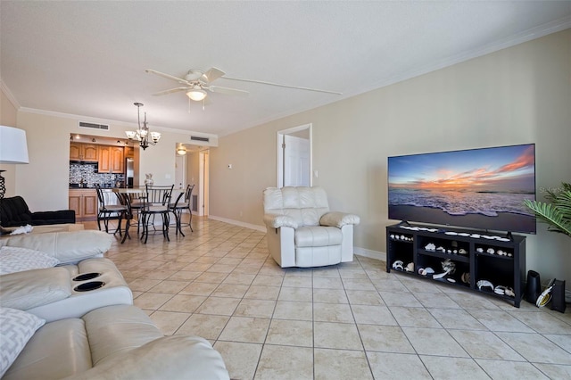 living area featuring light tile patterned floors, baseboards, visible vents, ornamental molding, and ceiling fan with notable chandelier