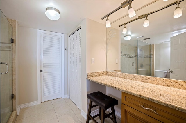 full bath featuring baseboards, a closet, a shower stall, and tile patterned floors