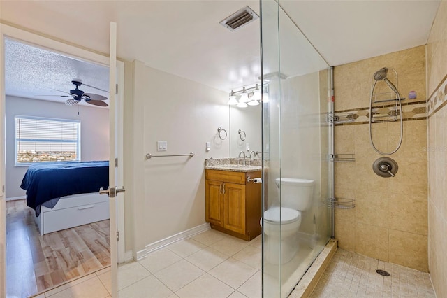 full bathroom featuring visible vents, connected bathroom, tile patterned flooring, a tile shower, and vanity