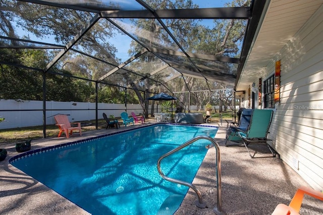 view of swimming pool featuring a fenced in pool, glass enclosure, fence, and a patio