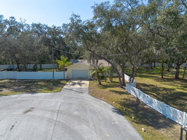 view of front of property with a garage, a front yard, and fence