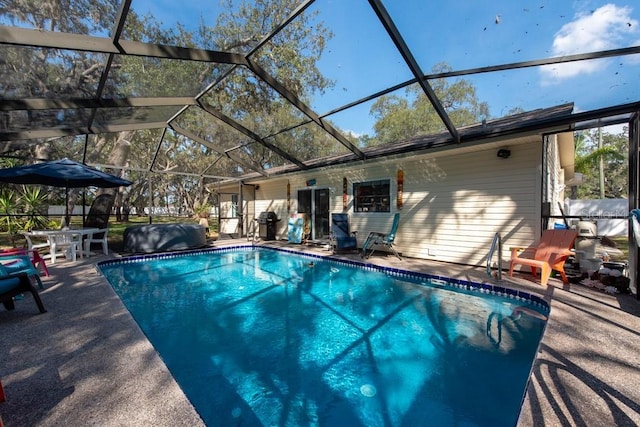 pool with a lanai and a patio area