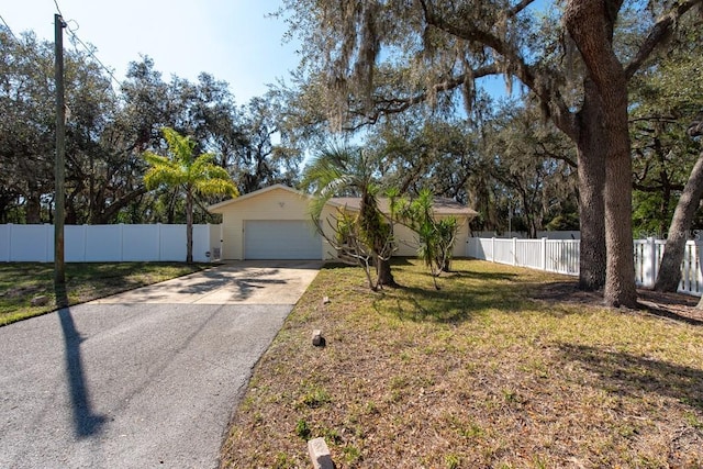 ranch-style home with fence and a front lawn