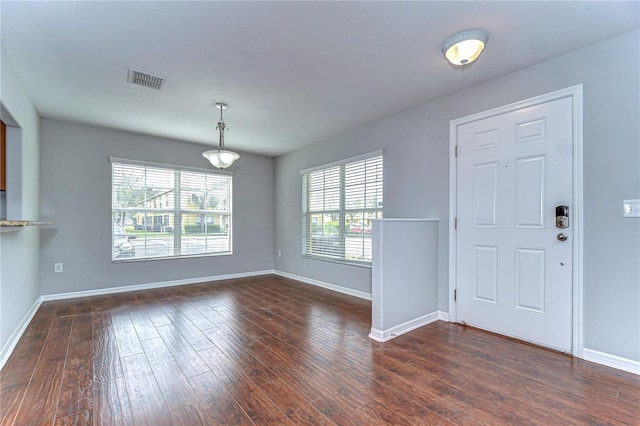 foyer featuring dark wood-style flooring, visible vents, and baseboards