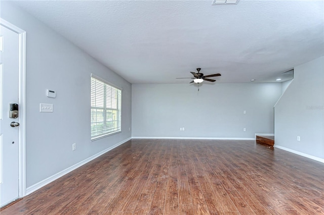 unfurnished living room featuring a textured ceiling, wood finished floors, a ceiling fan, and baseboards