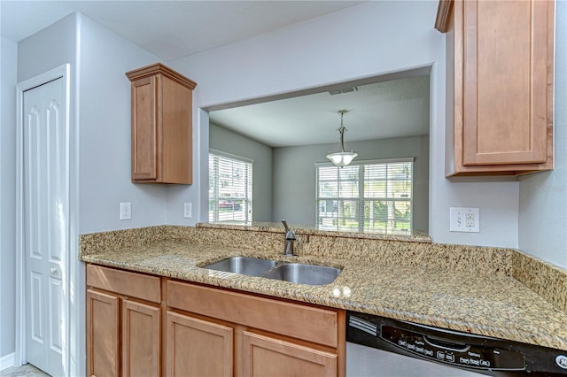 kitchen with stainless steel dishwasher, a sink, visible vents, and light stone countertops