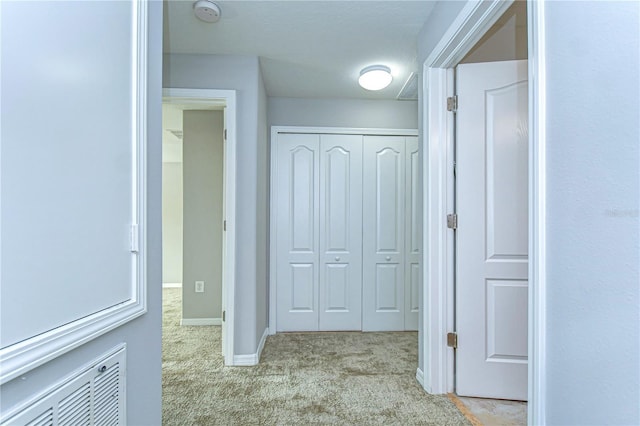 hallway with carpet and baseboards