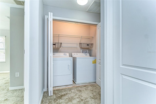 laundry room with laundry area, visible vents, baseboards, washer and clothes dryer, and carpet