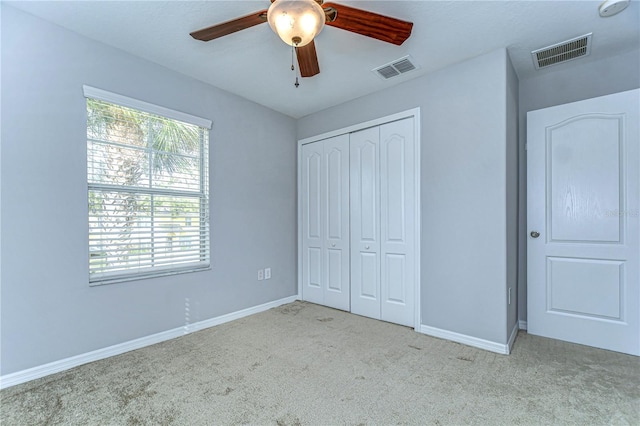 unfurnished bedroom featuring carpet, visible vents, and baseboards