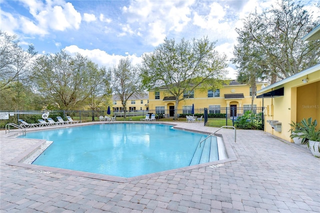 community pool featuring a patio area and fence