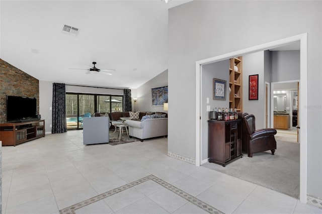 carpeted living room with visible vents, a ceiling fan, high vaulted ceiling, baseboards, and tile patterned floors