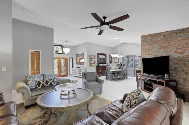 living room with ceiling fan with notable chandelier, vaulted ceiling, and light tile patterned floors