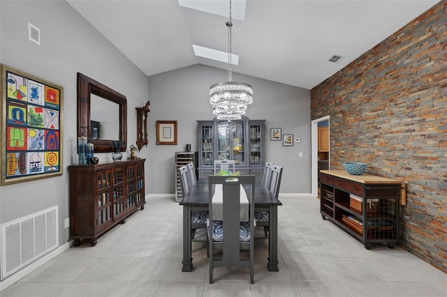 dining room featuring a chandelier, vaulted ceiling with skylight, and visible vents