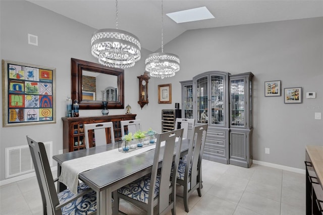 dining area with vaulted ceiling with skylight, visible vents, a chandelier, and light tile patterned flooring