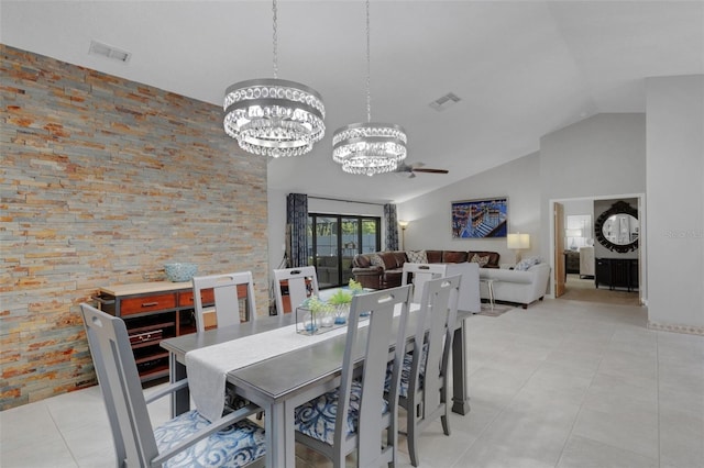 dining area with an inviting chandelier, light tile patterned floors, visible vents, and high vaulted ceiling