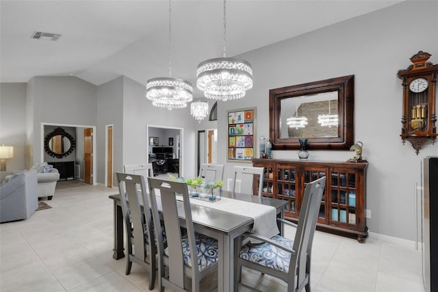 dining room with baseboards, visible vents, vaulted ceiling, and a chandelier