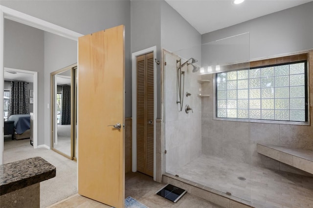 ensuite bathroom featuring connected bathroom, a closet, and tiled shower